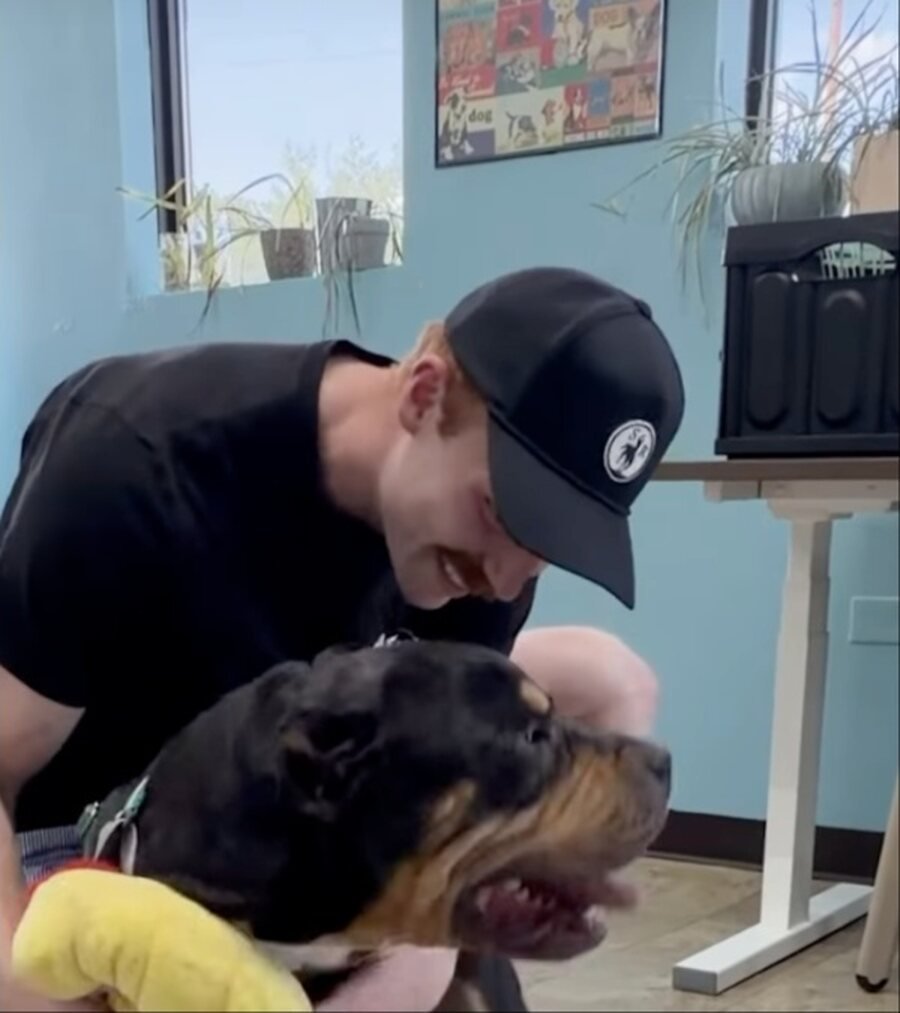 Scott Corbett leaning down to kiss the top of Braveheart's head